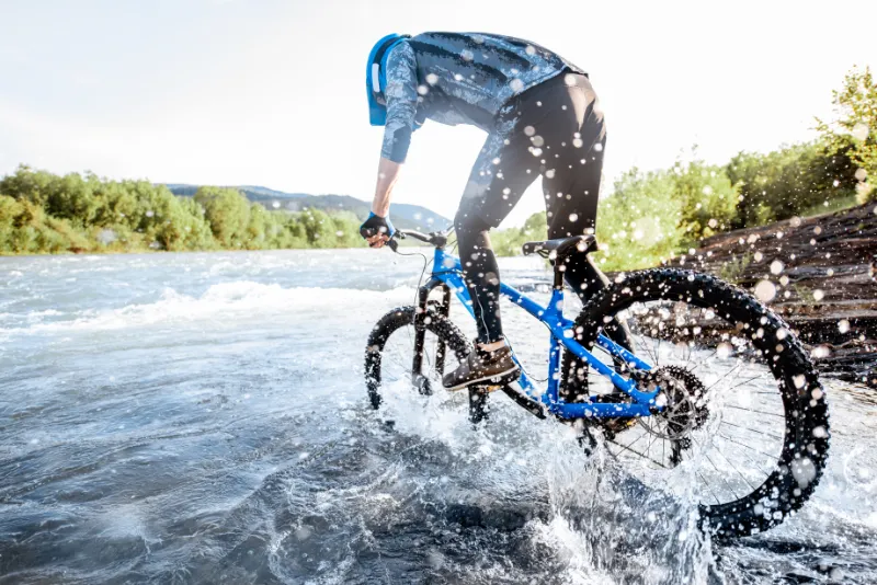 cyclist riding on the rocky riverside 2022 01 18 23 57 31 utc