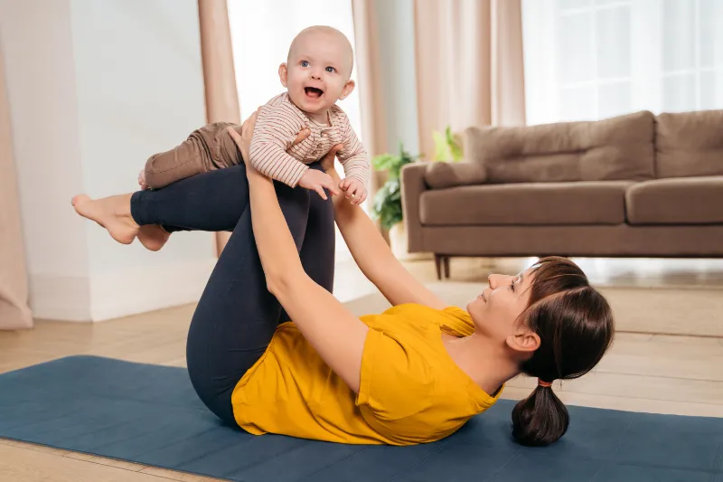 postnatal recovery mom practicing yoga with her i 2023 05 10 18 55 19 utc