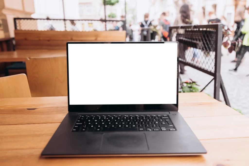 white laptop screen on the table in a cafe on the 2022 12 16 11 28 15 utc